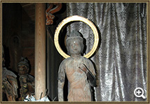 左腕を曲げ、右腕は垂らし、腰が左側に折れ体が右側に傾いている木造月光菩薩立像の写真